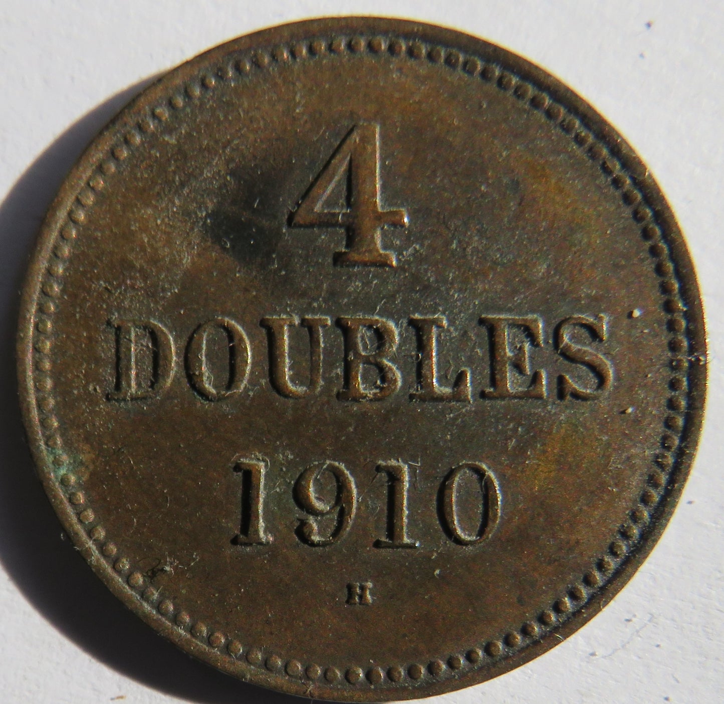 1910-H Guernsey 4 Doubles Coin