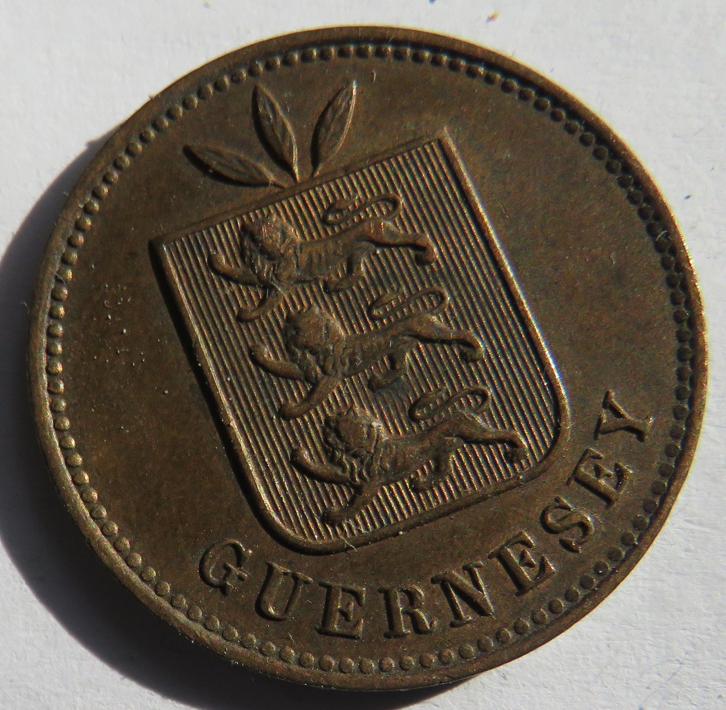 1910-H Guernsey 4 Doubles Coin
