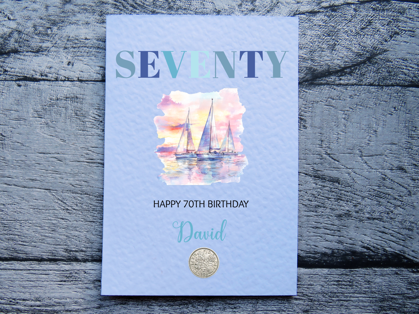 Sailing themed 60th birthday card with real 1966 sixpence, personalised with a name on a wooden surface