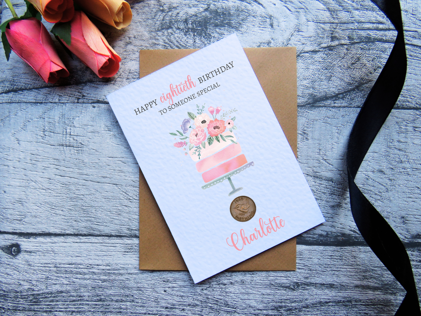 Cake 80th Birthday Card with Genuine 1946 Coin on wooden surface with black ribbon