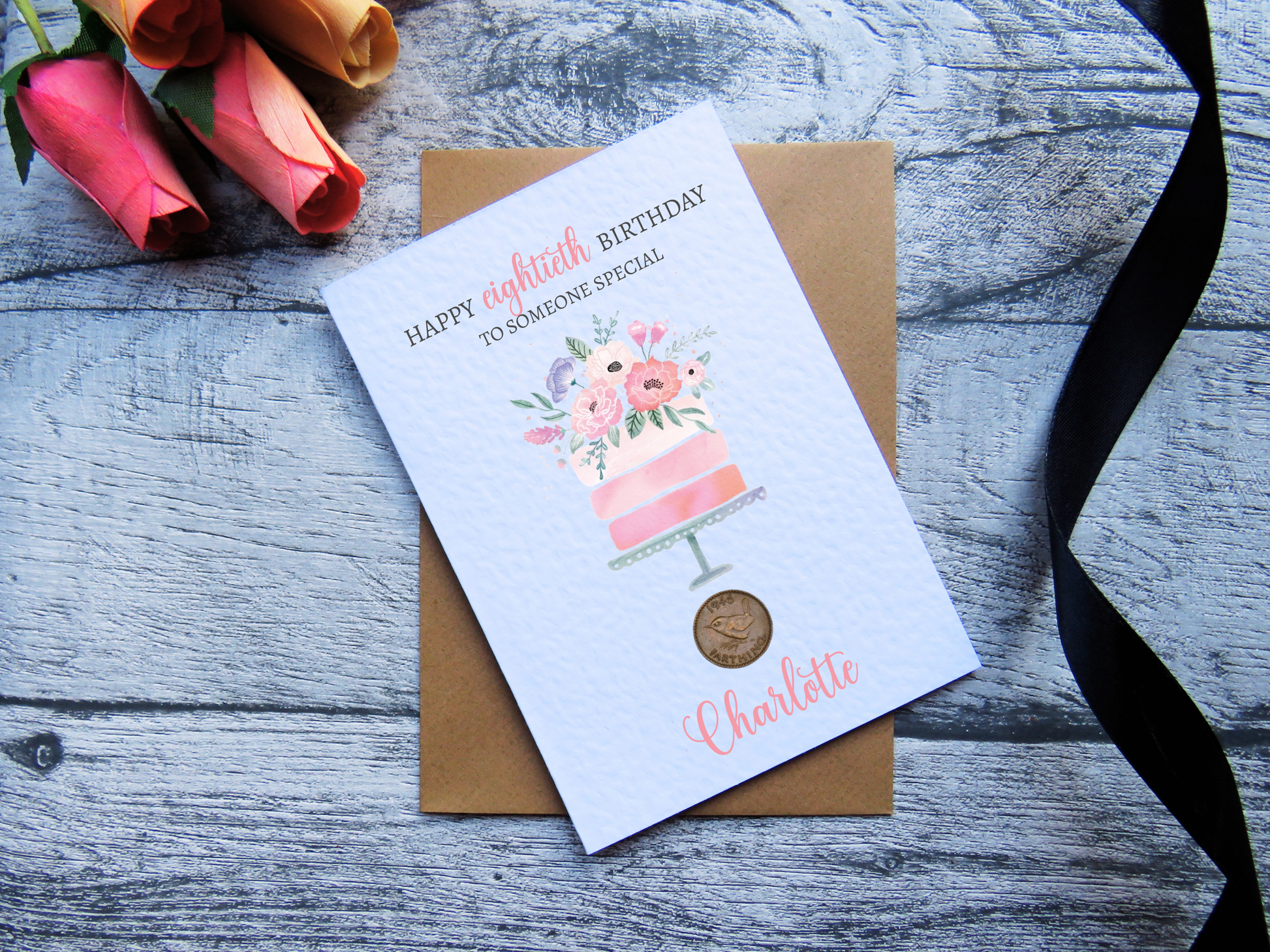 Cake 80th Birthday Card with Genuine 1946 Coin on wooden surface with black ribbon