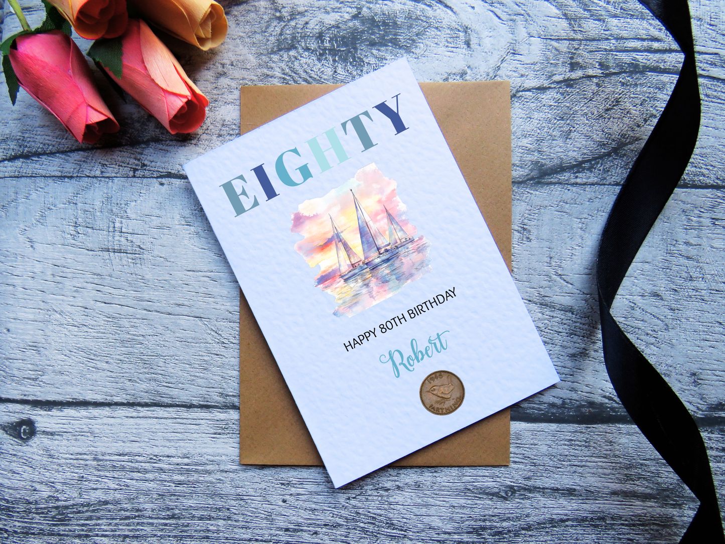 Sailing 80th Birthday Card with Real 1946 Coin on wooden surface with black ribbon