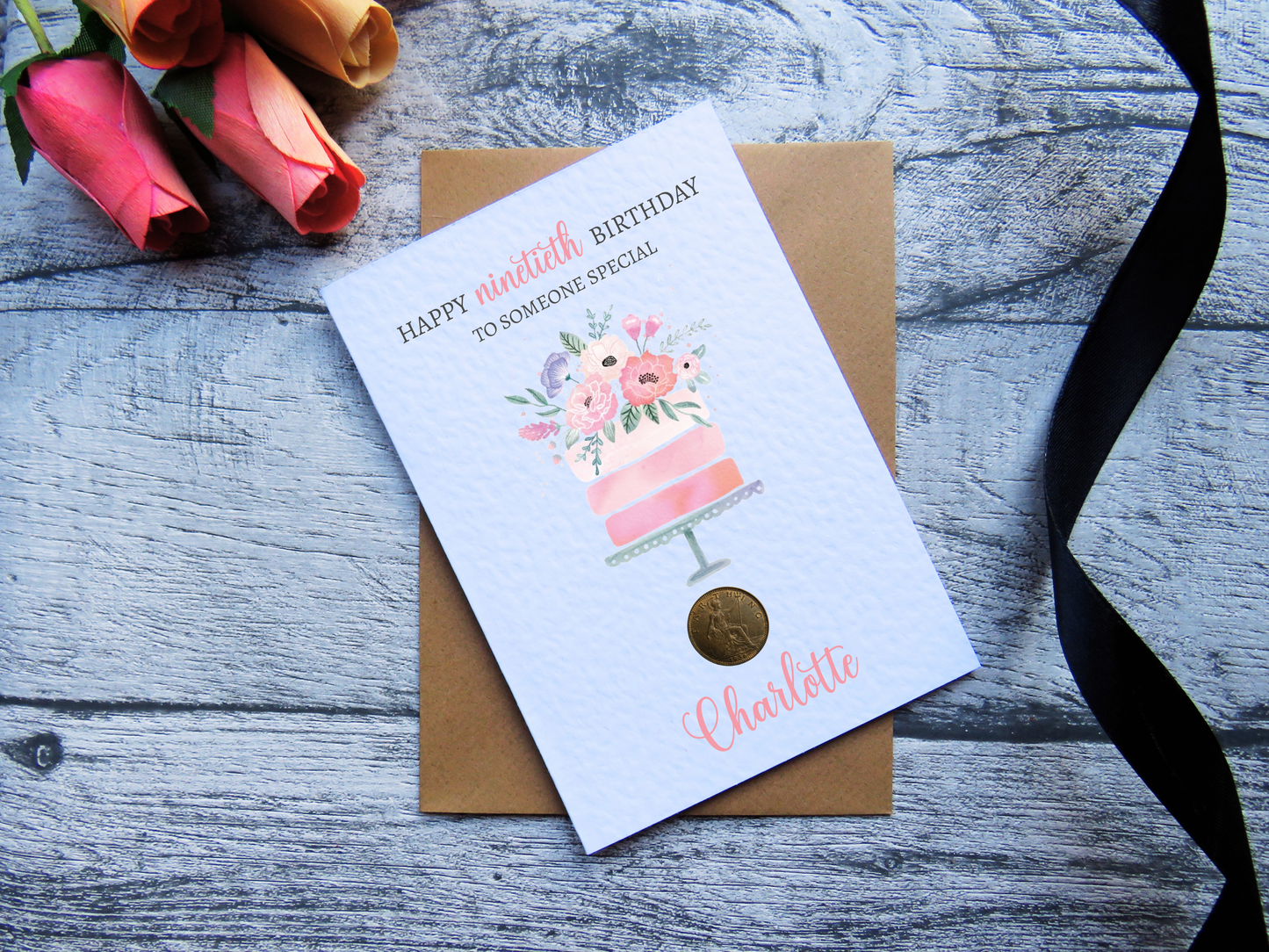 Cake 90th Birthday Card with Genuine 1936 Coin on wooden surface with black ribbon