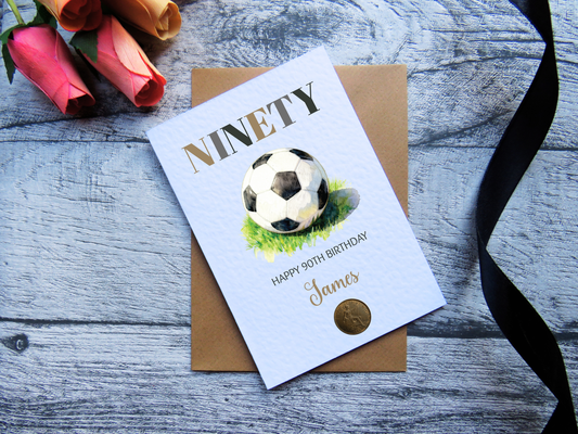 Football 90th Birthday Card with Genuine 1936 Coin on wooden surface with black ribbon