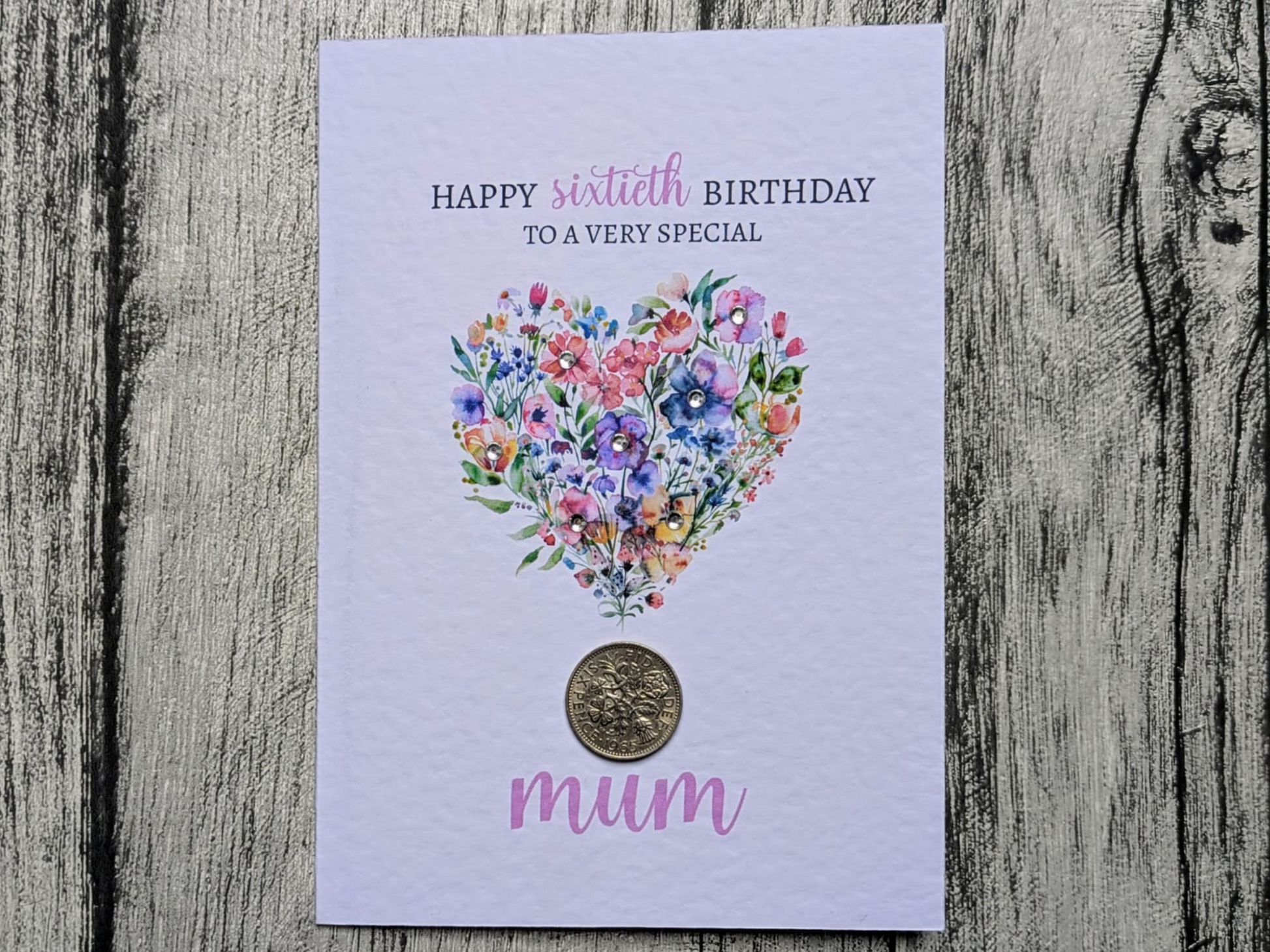 Floral heart 60th birthday card with real 1966 sixpence on wooden background